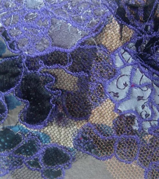 Textile work: violet lace worked over patterned netting